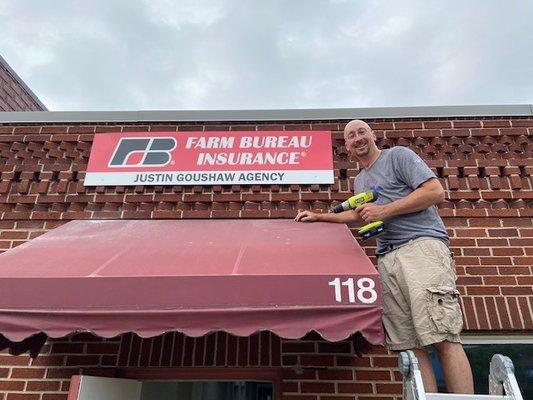 Installing the sign on the new office!