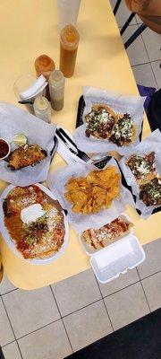 Left to Right Birria Taco, Chicken Enchilada plate, Elote, Tortilla Chips, Tacos (Lengua, Cavesa, Carnitas, Asada)