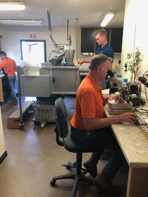 Owner/Working Partner Alan Butterfield reading a nematode sample while more are getting processed in the background.