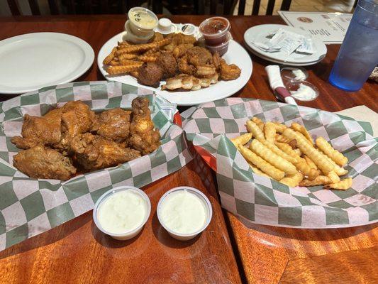 Seafood combo, fries (regular and sweet potato) and wings tossed in Cajun seasoning.