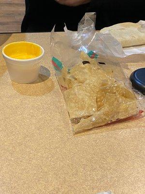 House-made queso and a bag of tortilla chips