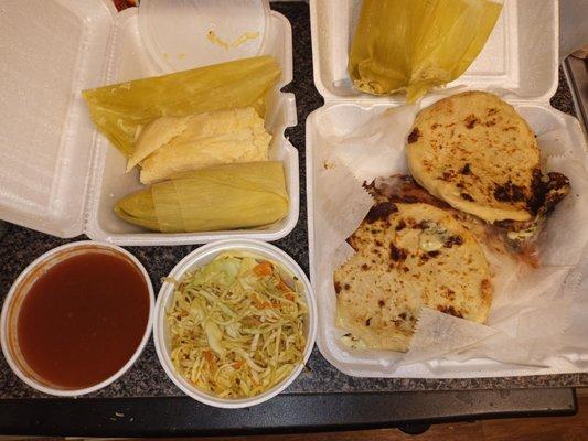 Left side tamales, red sauce and cole slaw. Right side papusas (and a husk in the top of the container).