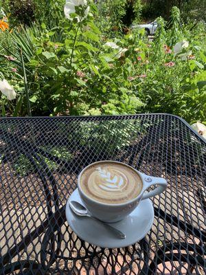 Enjoying a latte in the outdoor courtyard across the street