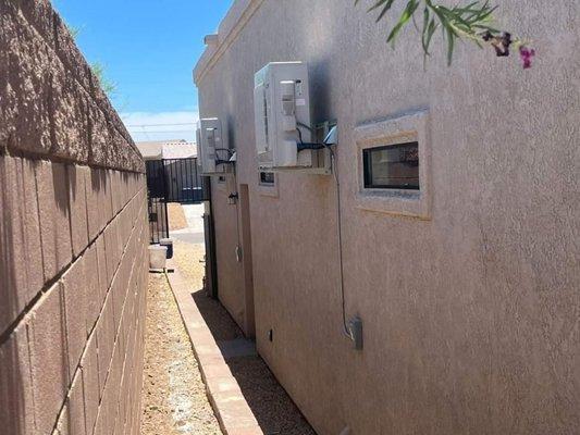 Mitsubishi ductless mini split mounted on garage wall.