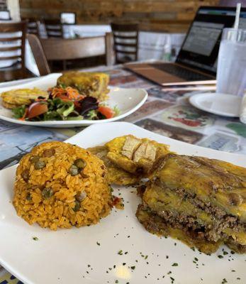 Pastelon accompanied by arroz con gandules & tostones