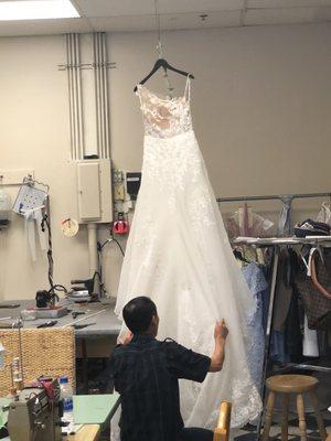 Working on a beautiful wedding dress.