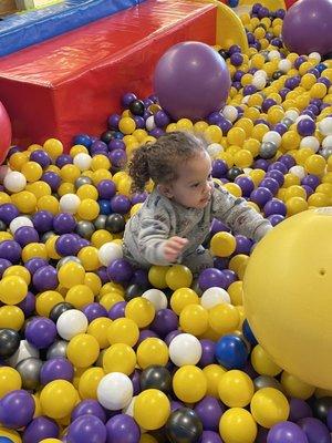 She loves everything about this place from the huge ball pit to the slides & the playhouse