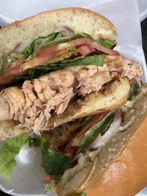 Slapping Salmon Sandwich Blackened Salmon on Brioche Bun, Lettuce, Tomato, Red Onion, and Cilantro Lime Aioli