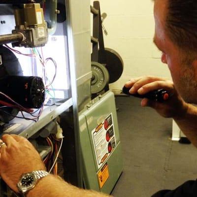 Cleveland home inspector Jay Brzezinski inspecting a home furnace.