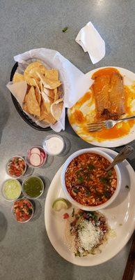 Pozole soup, chicken taco, chicken tamale, chios and some items from the salsa bar.