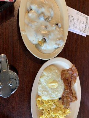 Biscuit and gravy, scrambled eggs, bacon and grits.