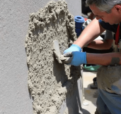 Johny repairing stucco foundation in knoxville.