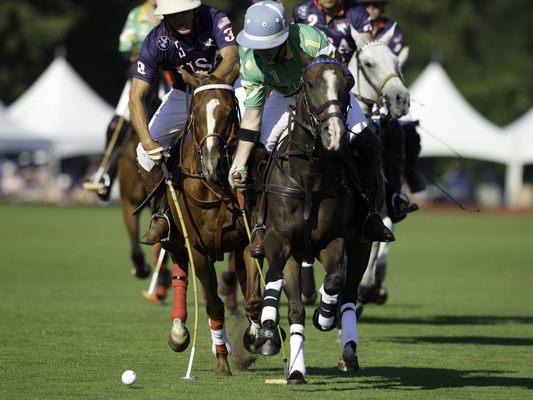 USA carries the ball against Ireland in a Newport International Polo Series public exhibition polo match.