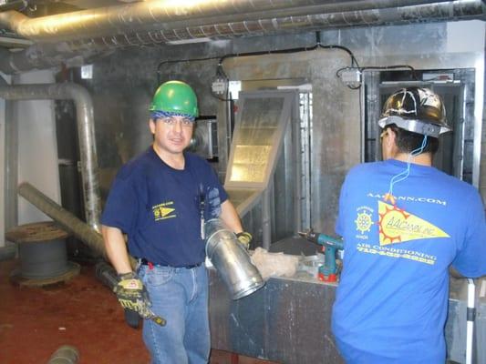 Gabriel installing duct work for Helix project.