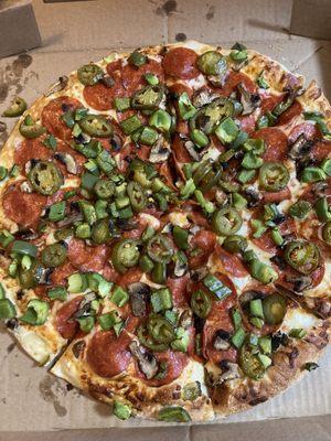 Pepperoni asked pizza with green peppers, mushrooms, and jalapeños