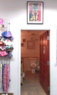 Large and clean bathroom with baby changing table and even diapers and wipes.