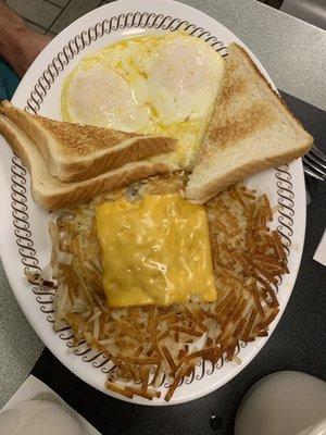 White toast , 2- eggs over medium, cheese on the hash brown