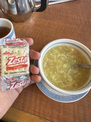 Bland egg flower soup served with saltines.