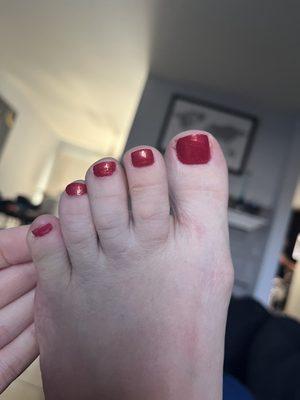 You can see nail polish on skin and there's a bubble in the toe nail