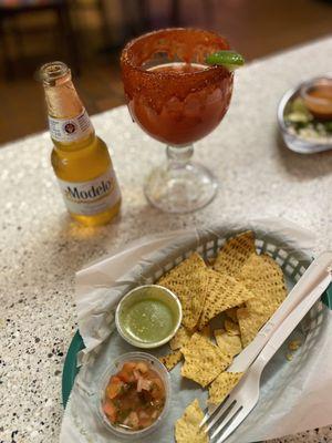 Complimentary chips and salsa and green sauce