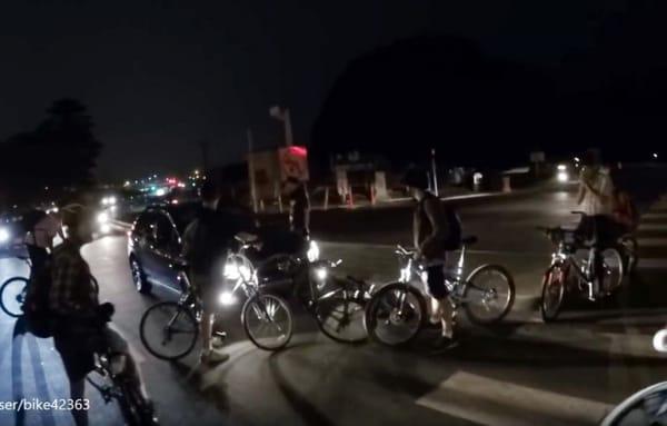 Critical Mass bikers harassing a woman and blocking her path.