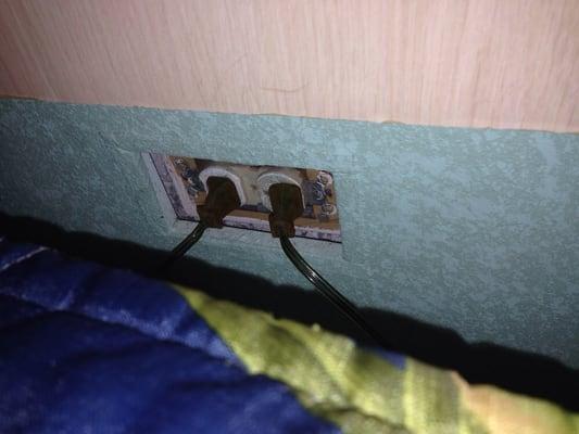 Outlet has no cover next to bed!