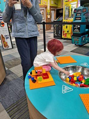 My granddaughter  age 2 at the kego table