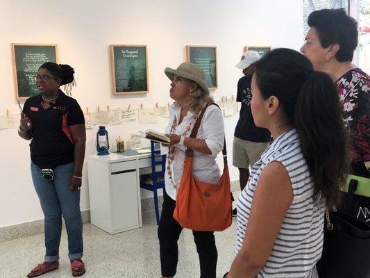 Tour guests learning about Haitian artwork during Little Haiti walking tour and tasting