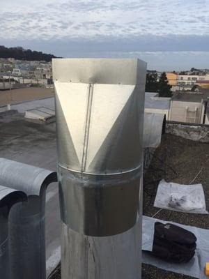 The custom fabricated chimney cap/adaptor.