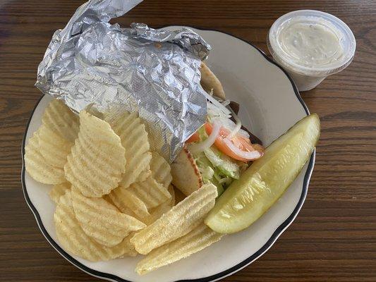 Gyro with chips, pickle, and tzatziki sauce