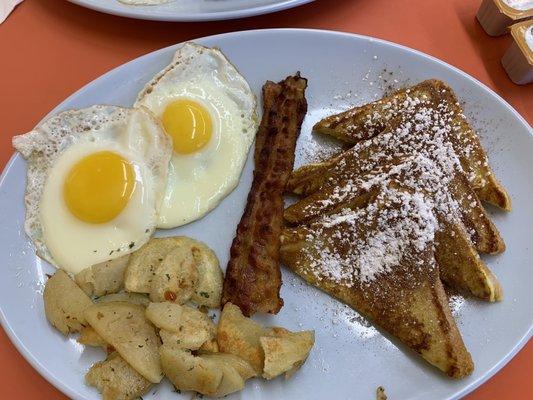 French toast breakfast w/ 2 eggs sunny side up, bacon, and home fries. $10.99