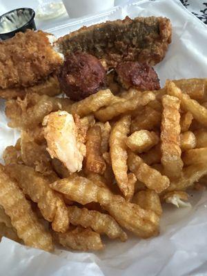 Hard, oily French fries good in old grease and undercooked shrimp batter falling off. overcooked hush puppies. French fries are not edible.