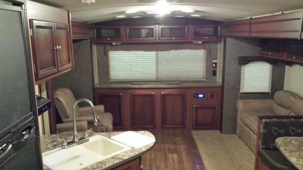 Large 31ft travel trailer, has TV, 2 recliners, a couch, a dinette, full kitchen, full bathroom, and nice master bedroom.