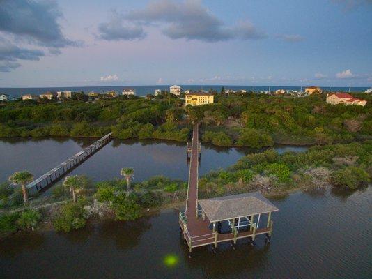 Dock on the river, house and the ocean across the street.