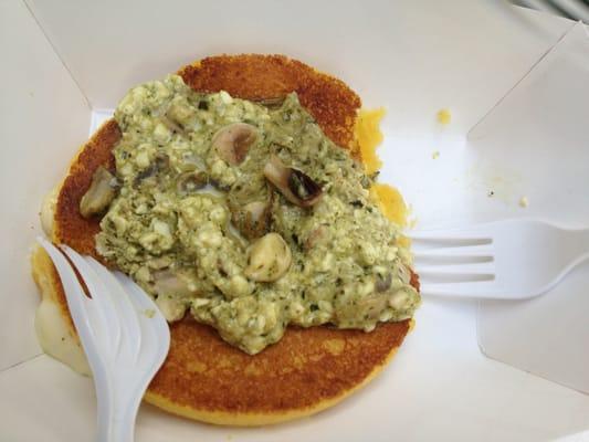 Melty cheese inside sweet corn cake, topped with feta, pesto, and mushrooms.