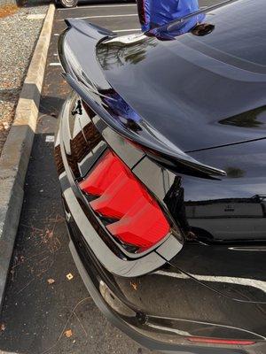 OEM spoiler was removed and aftermarket aggressive spoiler was installed in Ford Mustang