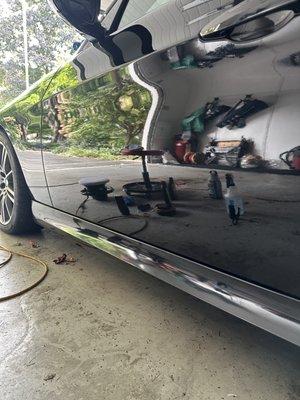 Compounded, polished, and waxed paint on black car