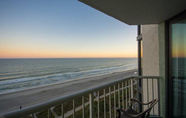 Oceanfront balcony at sunset