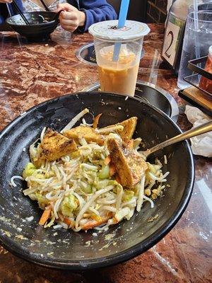 Noodles bowl with fried tofu and veggies. Thai tea.