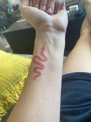 Healed hot pink snake tattoo by Zac