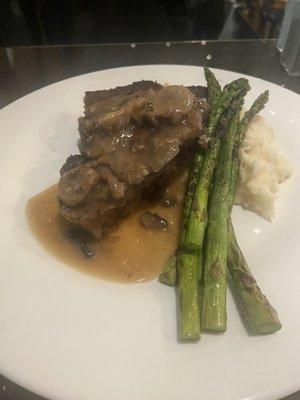 Meatloaf with mushroom gravy, asparagus, and garlic mashed potatoes.