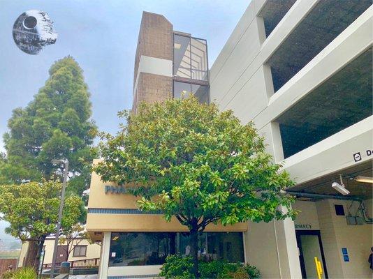 The pharmacy is connected to the parking structure.