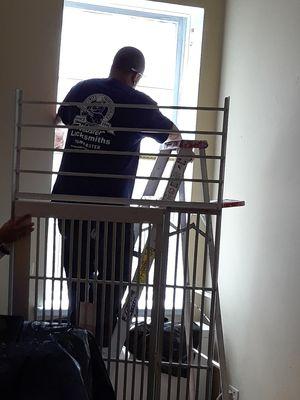 Webster Lock technician (who initially came to apartment to measure window) measuring window AGAIN because the gate they made does not fit.