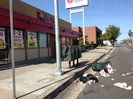 Overturned city trash bin in front of under-staffed store that can barely keep up with food service.