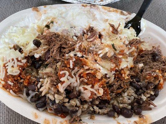 Burrito bowl with barbacoa, brown rice, black beans, cheese, sour cream, and hot salsa.