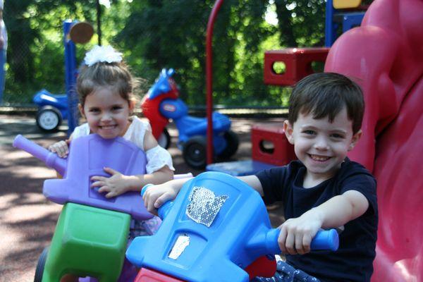 Riding around on the playground bikes.