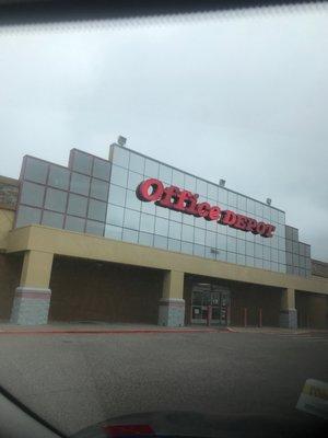 Office Depot store front located in strip mall next to Specs