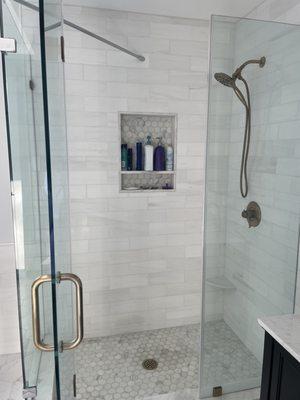 Master bath - dolomite shower walls, hex Calacutta gold marble for shower floor and niche, and porcelain large hex for the bathroom floor.