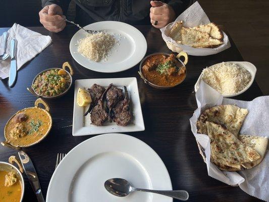 Rack of Lamb, garlic naan, cheese naan, lamb curry, and chicken soup.