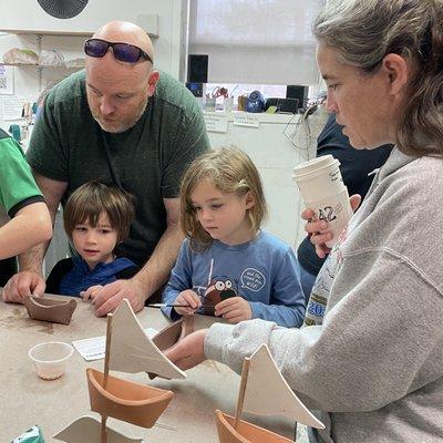 Children and adults at a hand building event.